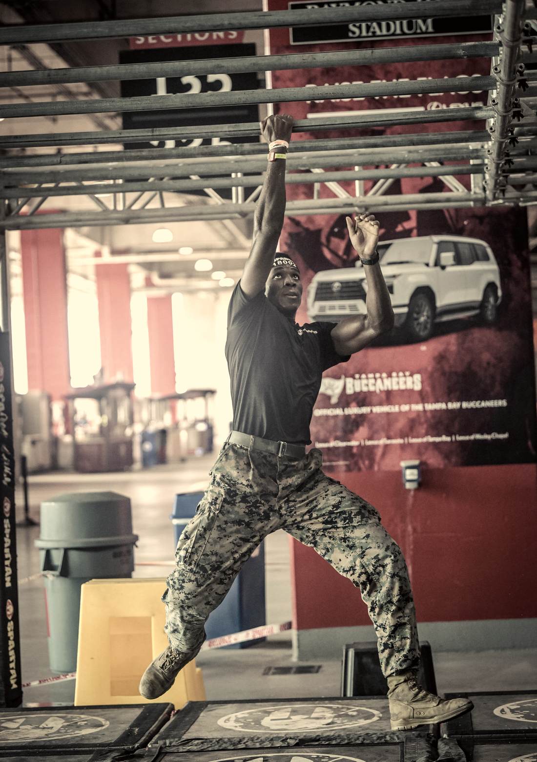 Swinging one handed across the overhead bars at the Spartan Stadion