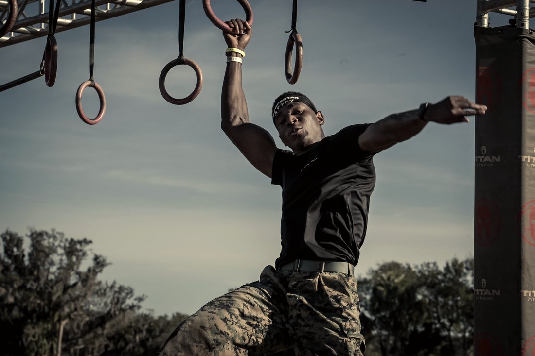 Hanging from the rings mid swing at the Spartan Super